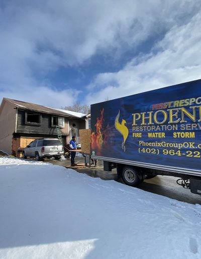 Phoenix Restoration truck on scene of house fire