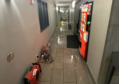 commercial water restoration to dry and clean up water in hotel hallway